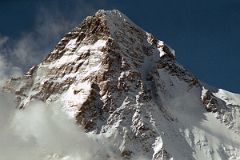 
The K2 West Face shines in the late afternoon sun from Concordia. The K2 West Ridge is on the far left. The Southwest Pillar separates the sunny west face from the K2 South Face. The Great Serac is just in shadow to the right below the K2 Summit. The K2 Shoulder is farther down to the right, partially in the sun. The K2 West Ridge was first climbed by Japanese Eiho Otani and Pakistani Nazir Sabir, reaching the K2 summit on August 7, 1981.
